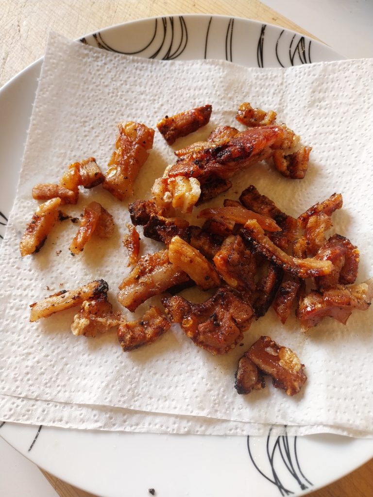 Bite-size pork crackling drained and salted on kitchen paper, fresh off a Big Green Egg Large kamado