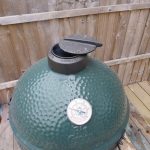 The Big Green Egg Large with its lid closed, on a delivery pallet in a London garden