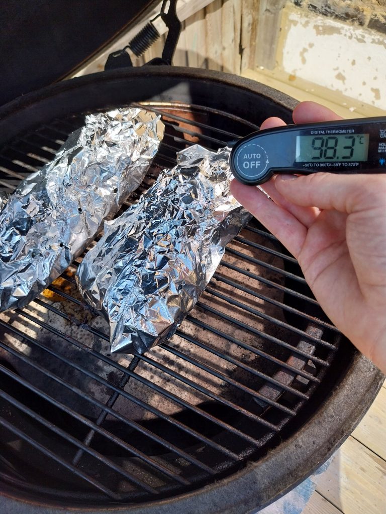 Beef short rib wrapped in heavy-duty foil and back on the grate of the BGE Large after the wrap, internal climbing through 88°C at a steady 115°C dome.