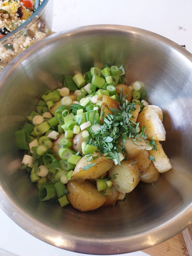 Roast potatoes folded with smoky mayonnaise and tarragon, finished off a Big Green Egg Large kamado