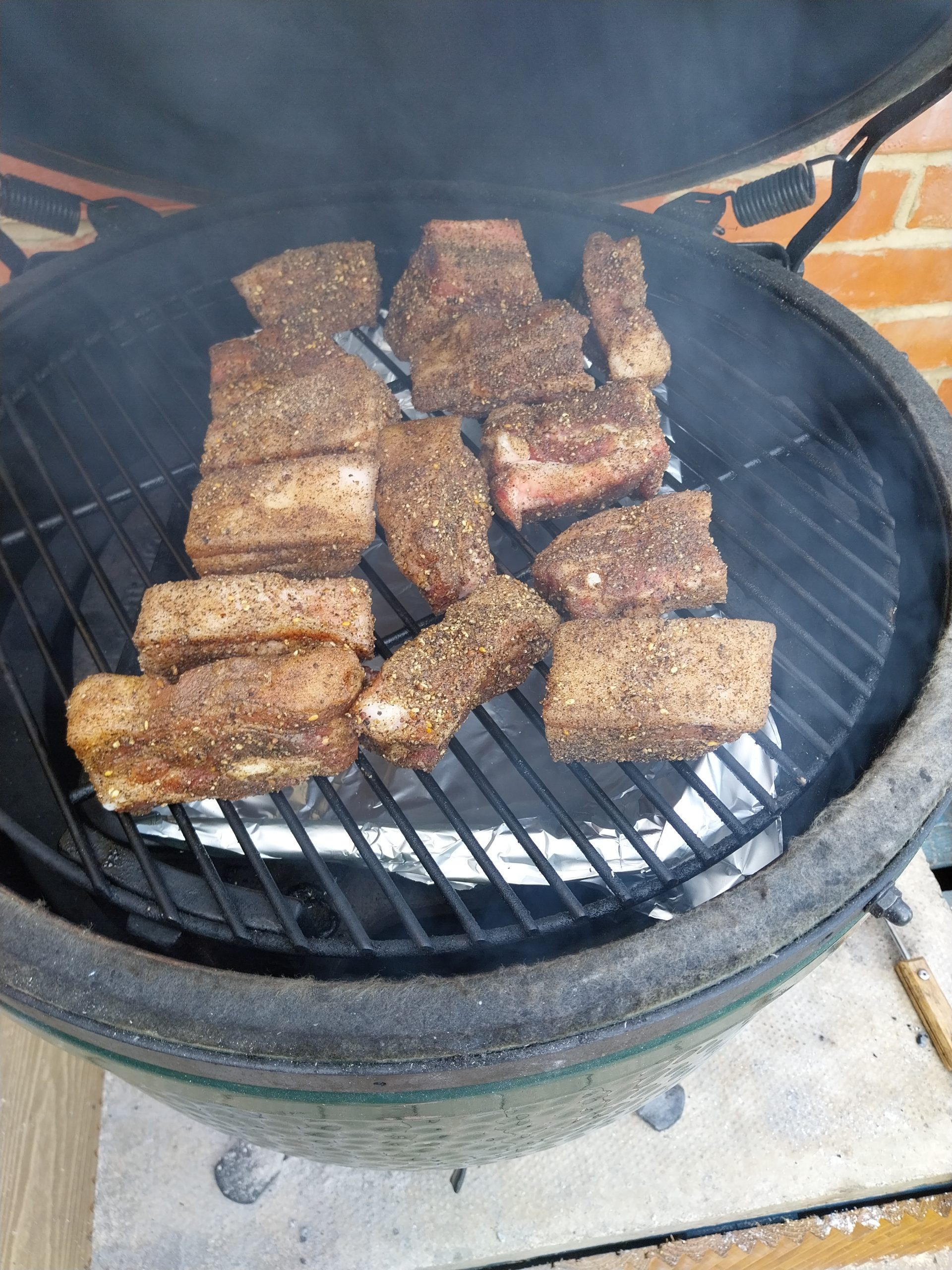 Rubbed pork belly cubes going onto the BGE Large grate at 110°C dome indirect with the ConvEGGtor in for indirect heat — phase 1 begins at half-eight.