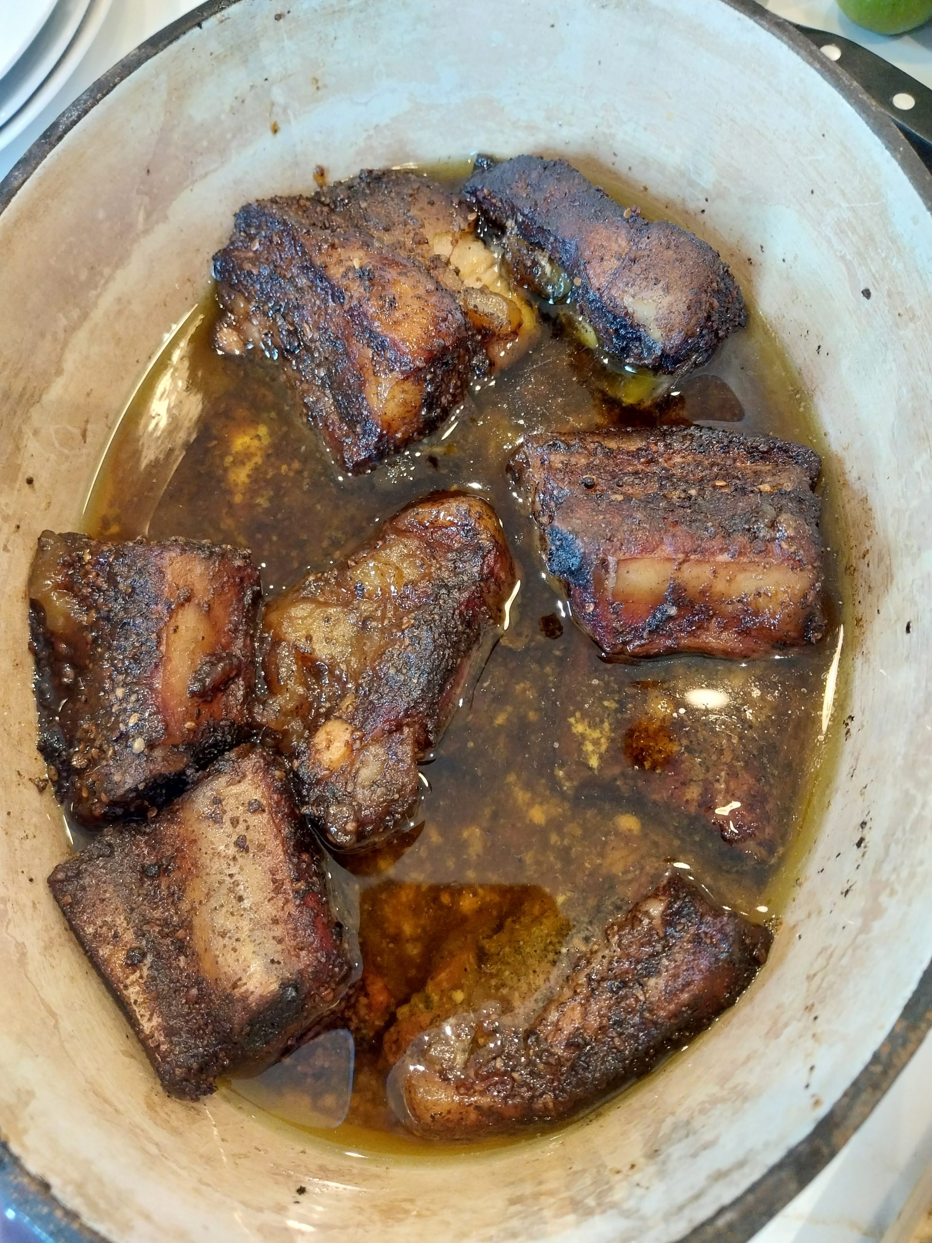 Pork belly burnt ends glazed with Sharwood's mango chutney, plated with heritage tomato salad, quick-pickled red onions and Middle Eastern rice on the BGE Large — dinner at eight after an eleven-hour cook.