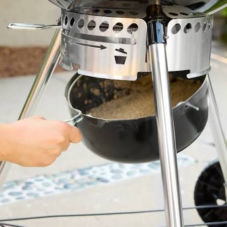 Weber Master-Touch GBS 57cm underside — the One-Touch cleaning system with three sweeping vanes feeding ash into the removable high-capacity ash catcher pan.