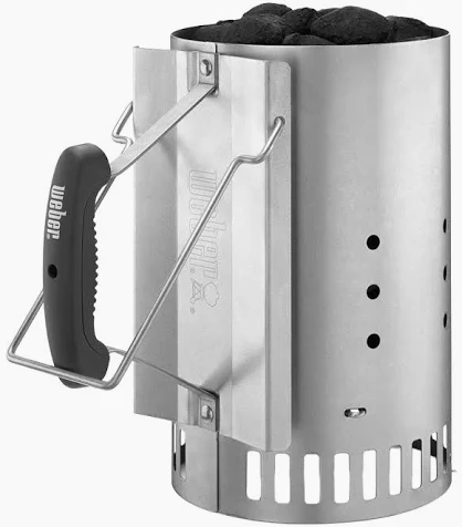 Weber Rapidfire chimney starter, galvanised steel with a black moulded handle and wire heat shield, filled to the top with charcoal briquettes