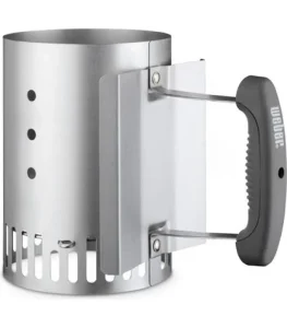 Weber Rapidfire Compact chimney starter, empty, with a black moulded handle, wire heat shield and slotted vents around the base