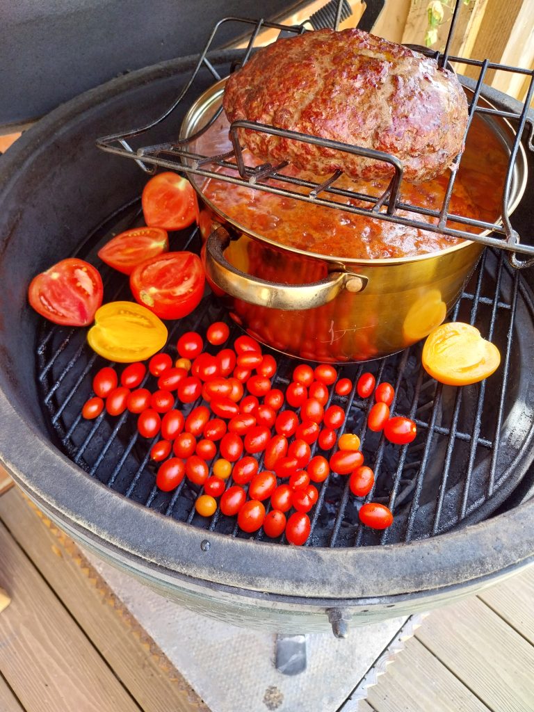 Tomatoes going onto the grid for the salsa, cherry tomatoes and halved bigger ones, next to the chilli pot with the mince on its rack above.