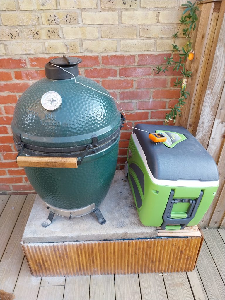 The Big Green Egg with the TP20 lead coming out of the top vent and the transmitter sitting on a green cool box beside it