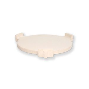 Big Green Egg ConvEGGtor — a pale cream ceramic plate with three short square legs on the rim, photographed at a low angle on white