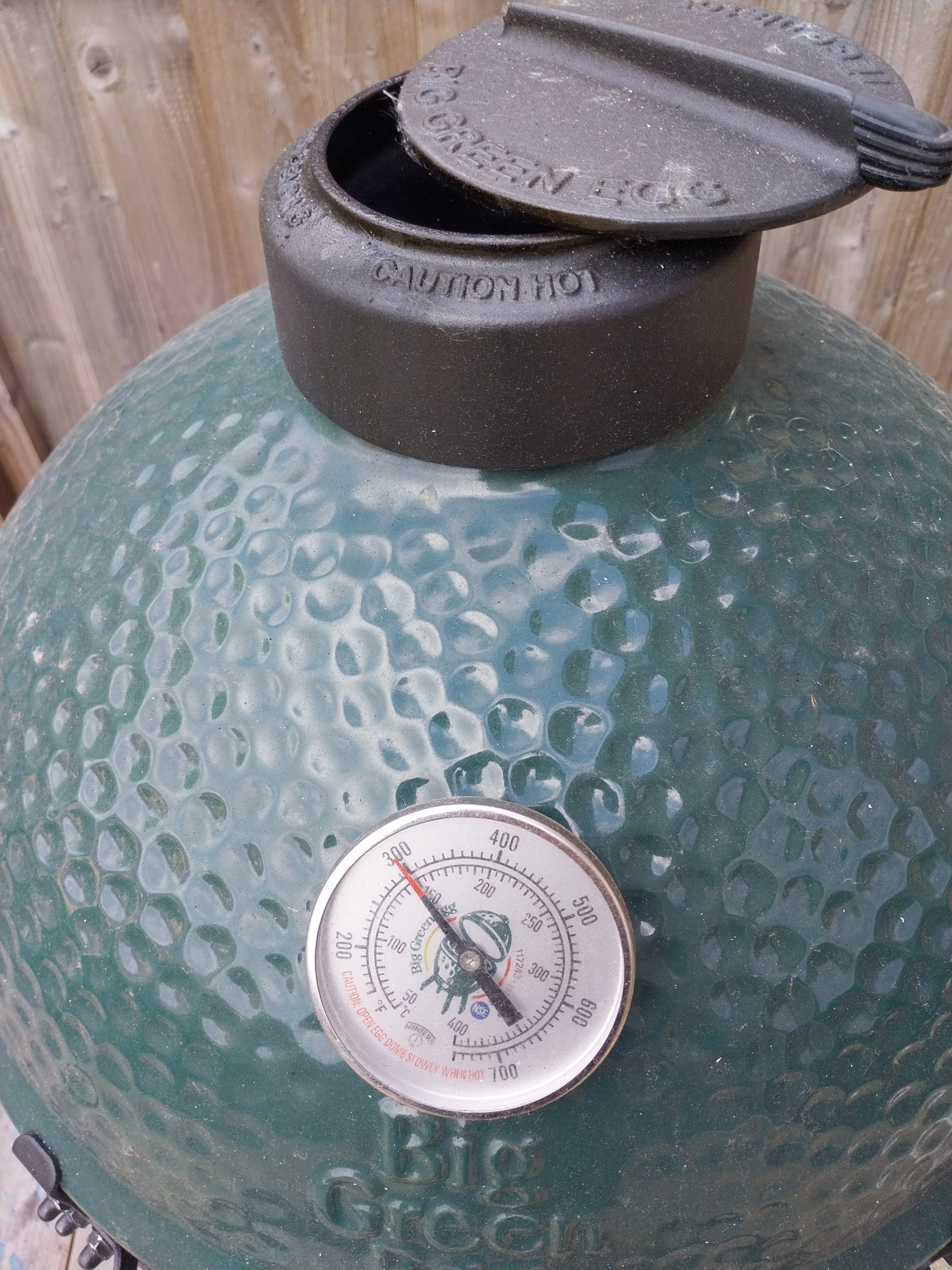 The cast-iron daisy wheel on the BGE Large’s dome partly closed, with the dome thermometer alongside