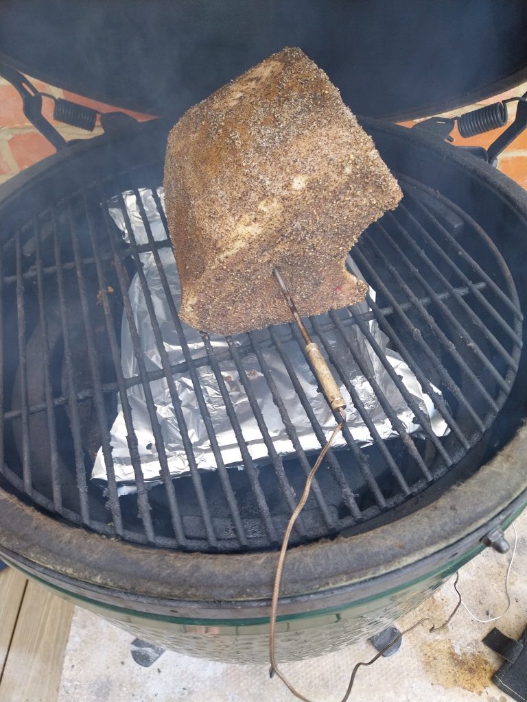 A bone-in pork loin on the Big Green Egg grate with the TP20 probe pushed into it