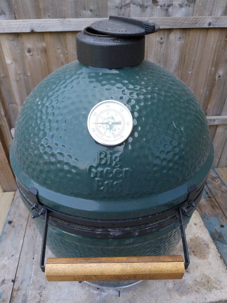 Big Green Egg Large with the lid closed, the top vent open a crack and the dome thermometer at about 115°C (239°F).