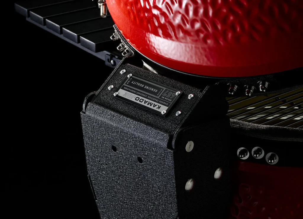 Kamado Joe Classic III — close-up of the Air Lift hinge housing at the back of the grill, under the red dome. Image: Kamado Joe.