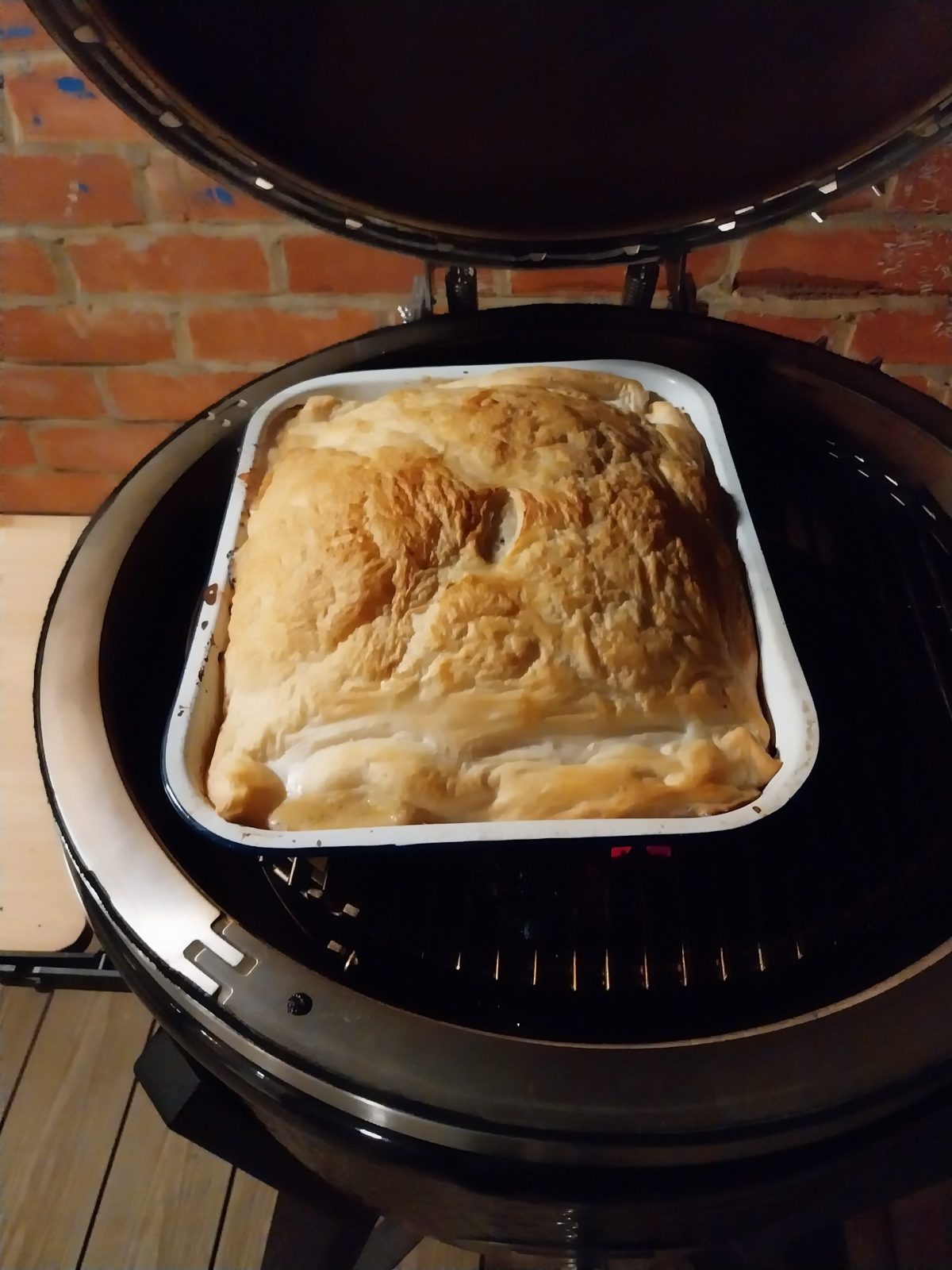 The pie on the Monolith's grid, the pastry risen and golden