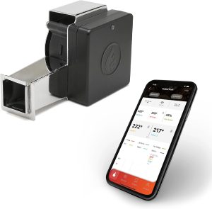The Flame Boss 400 kamado kit: a black box with a flame logo on a short silver duct, beside a phone showing temperatures in an app.