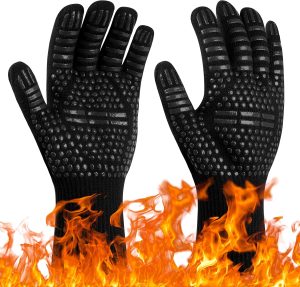 A pair of black knitted gloves with black silicone grip dots, above an illustration of flames. Image: Amazon UK.
