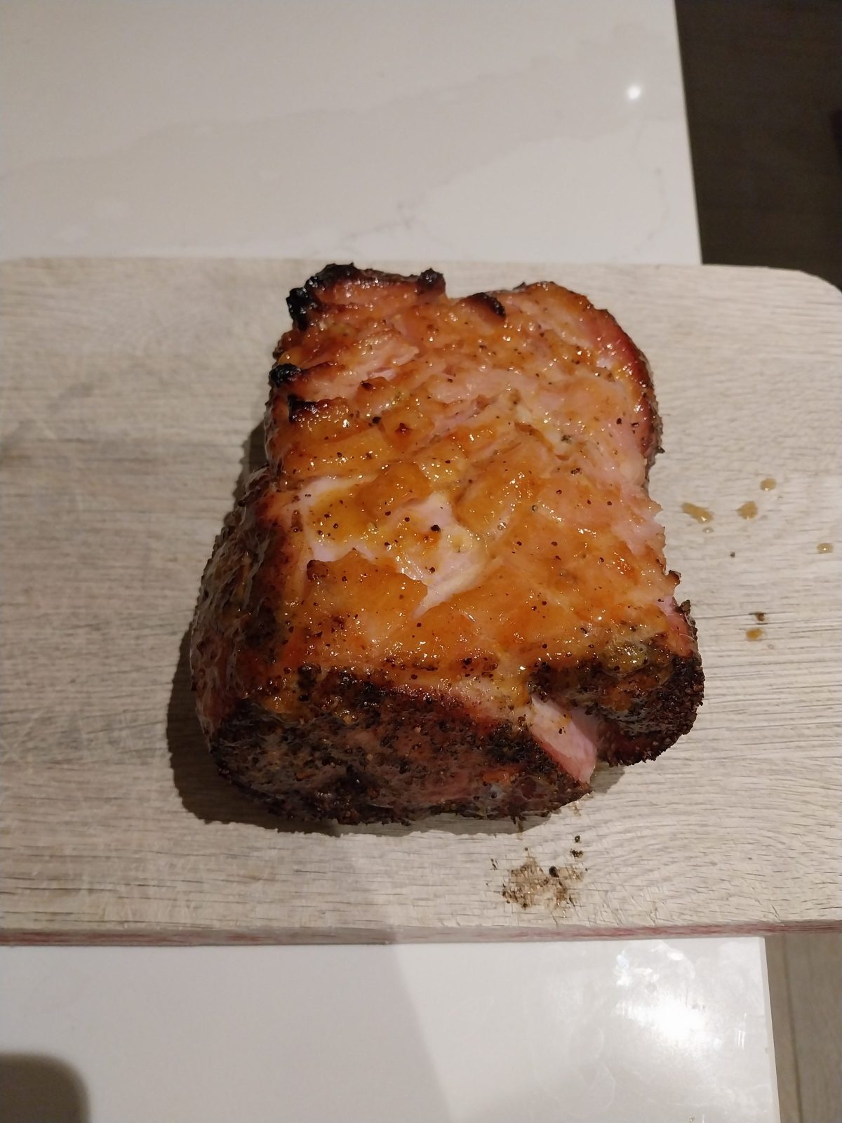 A glazed gammon joint on a wooden board