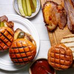 Sliced smoked brisket in toasted buns with pickles, from HG Walter's brisket listing.