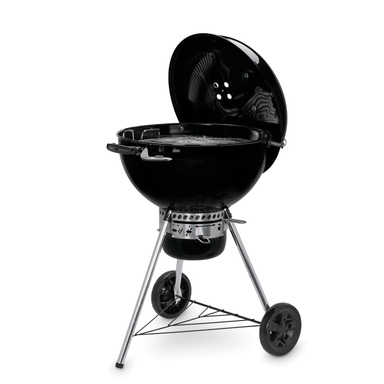 The Weber Master-Touch GBS with its lid hooked onto the side of the bowl