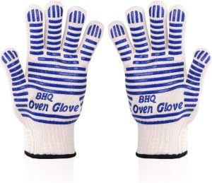 A pair of white knitted gloves with blue silicone stripes, printed Oven Glove across the palm, on a white background. Image: Amazon UK.